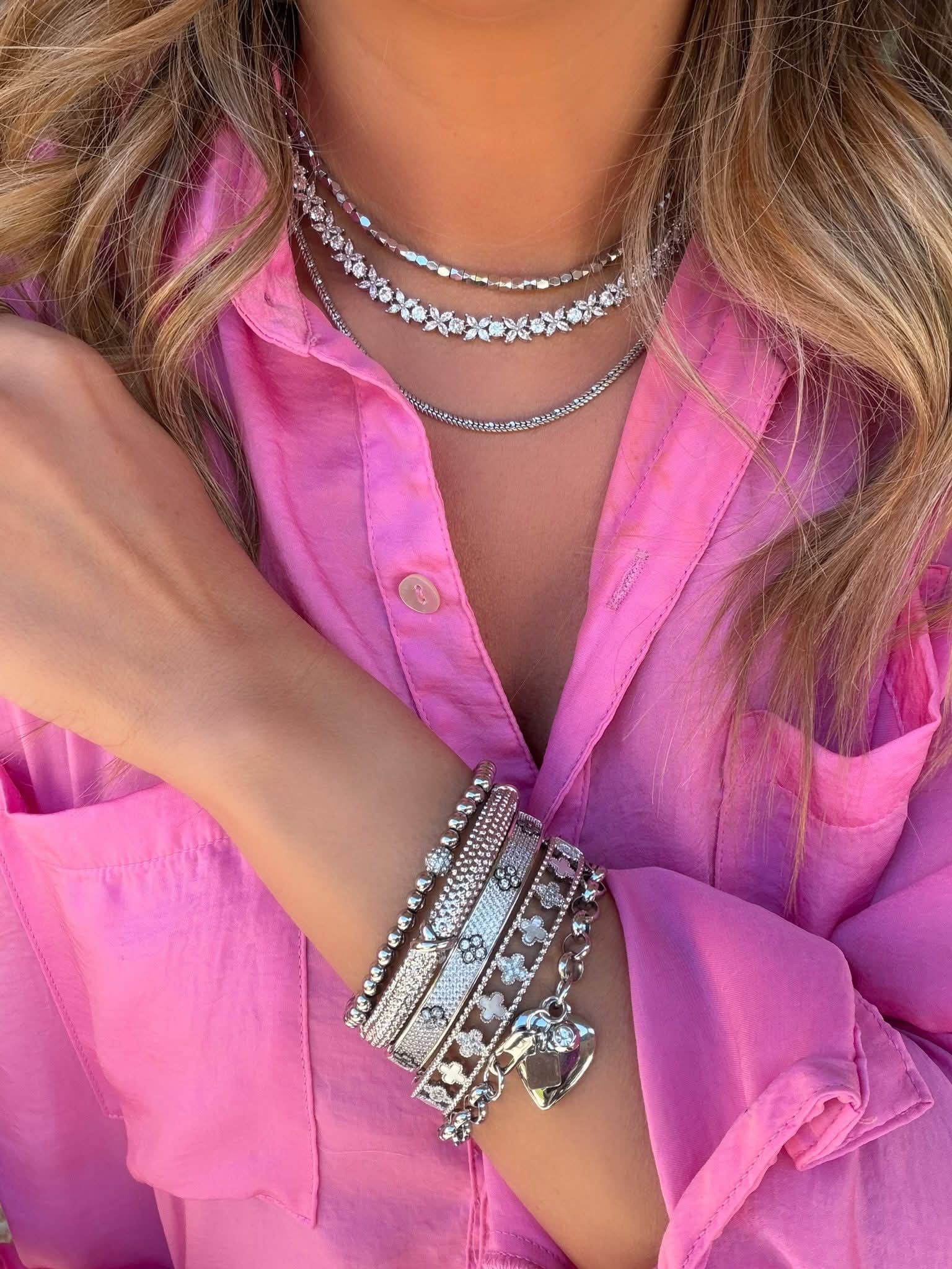 Stylish accessories on woman's wrist and neck
